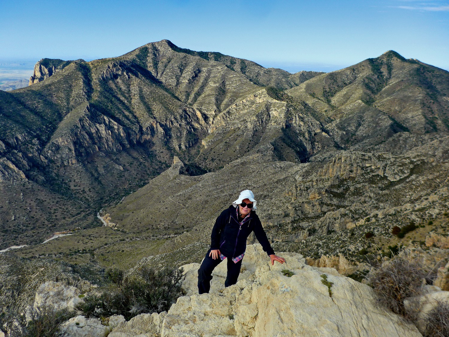 Marion on top of 2550 meters high Hunter Peak with Guadalupe Peak in the background